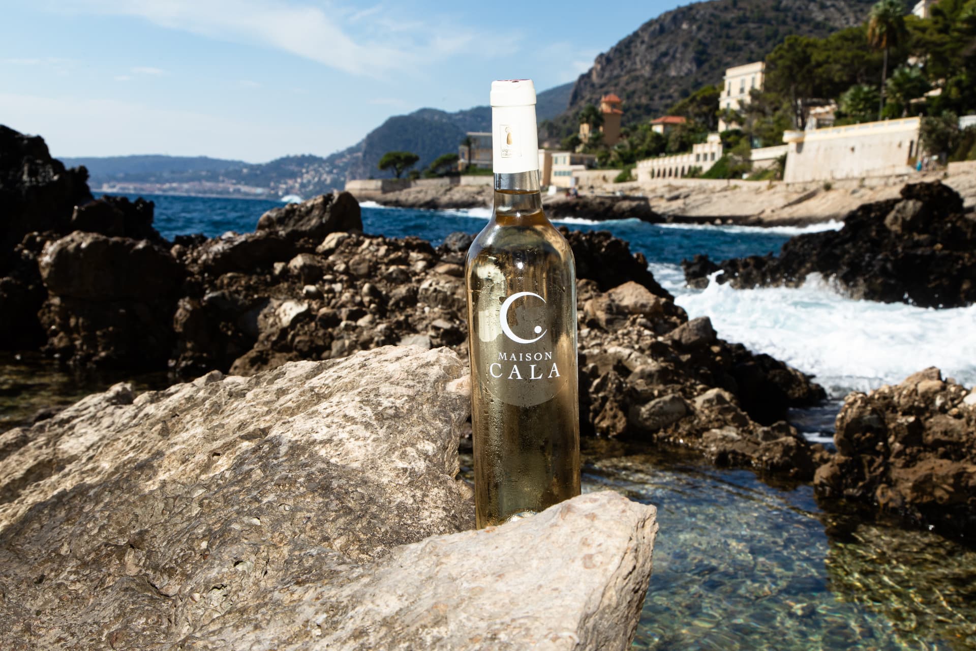 Maison Cala Rosé bottle on Mediterranean rocks